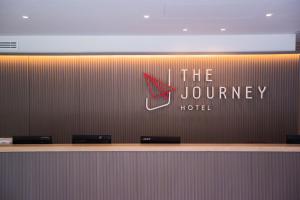 a sign for the jordan journey hotel on a wall at The Journey Hotel Laksi in Bangkok