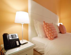 a bedroom with a phone on a night stand next to a bed at Rossio Apartments in Lisbon