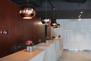 a row of tables in a restaurant with flowers on them at Star inn Lisbon Airport in Lisbon