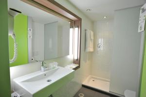 a bathroom with a white sink and a shower at Travelodge Málaga Airport in Málaga