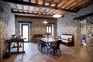 a dining room with a table and chairs in a building at Residenza d'Epoca Borgodifiume in Fiumefreddo Bruzio