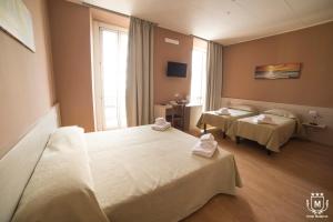 a hospital room with two beds and a window at Hotel Moderno in Lecco