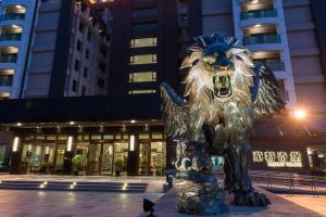 a statue of a lion in front of a building at Fantasy Palace in Yuchi