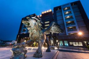 a metal statue of a lion in front of a building at Fantasy Palace in Yuchi