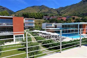 a resort with a swimming pool and mountains in the background at Sporting Club Resort in Praia a Mare