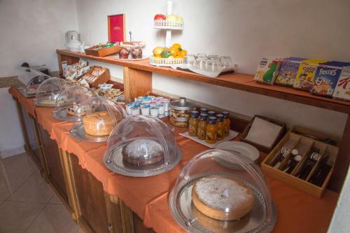 a buffet line with bread and other food on it at Palmed Hotel in Gizzeria