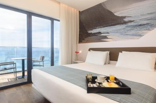 ein Hotelzimmer mit einem Bett und Meerblick in der Unterkunft Eurostars Cascais in Cascais