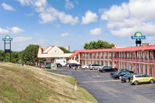 a parking lot with cars parked in front of a building at Days Inn by Wyndham Knoxville West in Knoxville