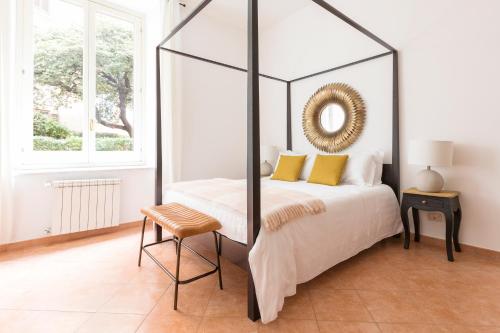 a bedroom with a canopy bed with yellow pillows at Sonder Piazza San Pietro in Rome