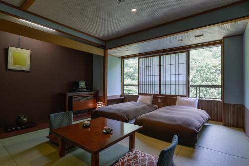 A bed or beds in a room at Takamiya Bettei Kuon