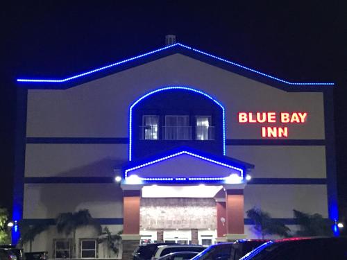 a blue bay inn sign in front of a building at Blue Bay Inn and Suites in South Padre Island