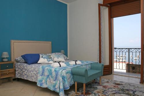 a bedroom with a bed and a blue wall at Piana delle Galee in Scilla