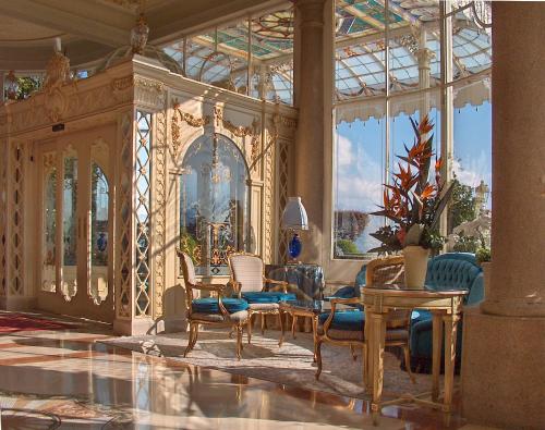 a living room filled with furniture and a large window at Grand Hotel des Iles Borromées & SPA in Stresa