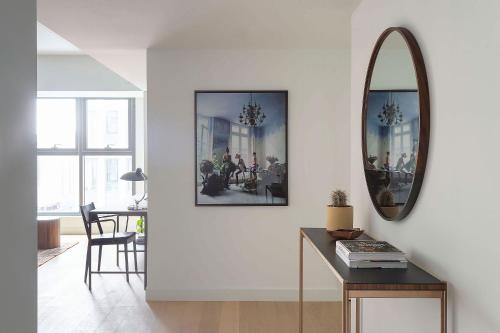 a living room with a mirror and a table at ROOST East Market in Philadelphia