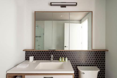 a bathroom with a sink and a mirror at ROOST East Market in Philadelphia