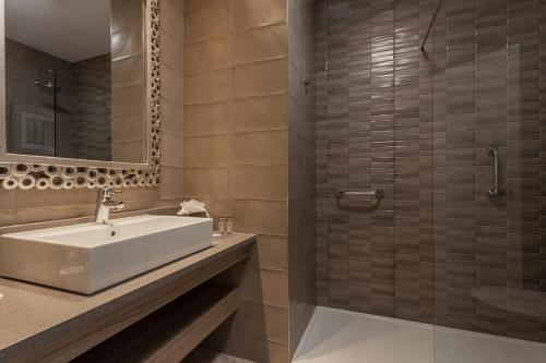 a bathroom with a sink and a shower at The Gleneagle Hotel & Apartments in Killarney