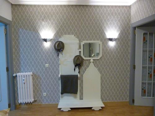 a room with a refrigerator and lights on a wall at Luengo House in León