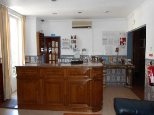 a kitchen with a large wooden island in a room at Residencial Joao XXI in Lisbon