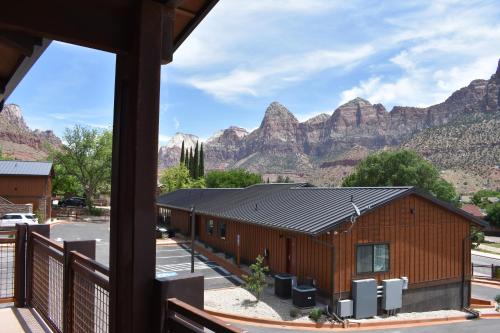 a view of a building with mountains in the background at Zion Canyon Lodge in Springdale