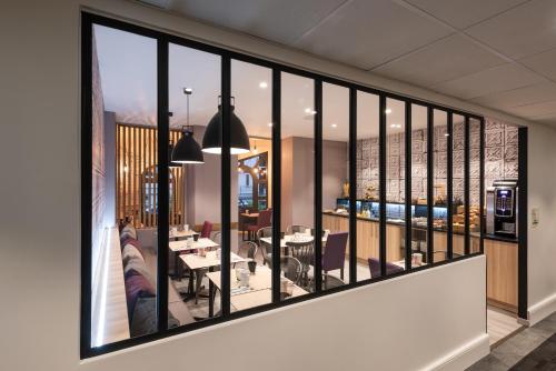 a view of a dining room and living room from a balcony at Campanile Annecy Centre - Gare in Annecy