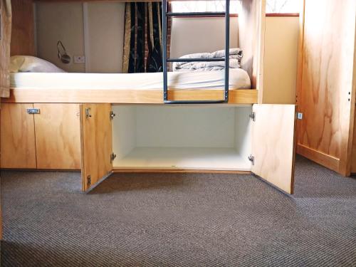 a room with a bunk bed in a room at The Flaming Kiwi Backpackers in Queenstown