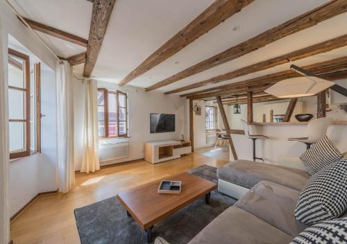 a living room with a couch and a table at Le Carré d'or - Appartement avec vue Cathédrale in Strasbourg