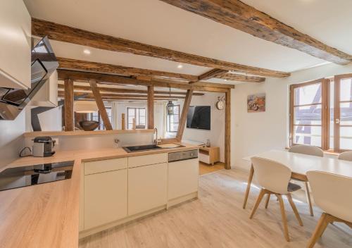 a kitchen and dining room with a table and chairs at Le Carré d'or - Appartement avec vue Cathédrale in Strasbourg