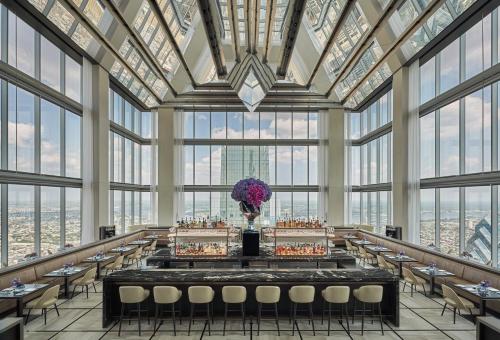 a large room with tables and chairs and windows at Four Seasons Hotel Philadelphia at Comcast Center in Philadelphia