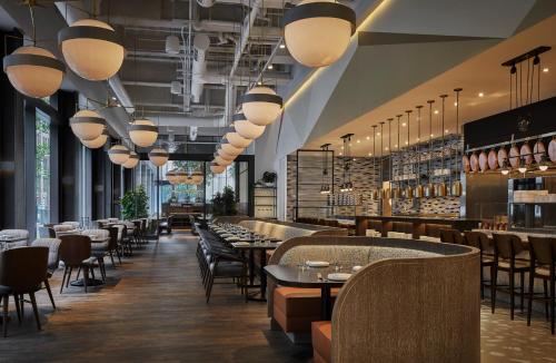 a restaurant with tables and chairs and lights at Four Seasons Hotel Philadelphia at Comcast Center in Philadelphia