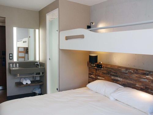 Tempat tidur dalam kamar di Ibis Budget Annecy sud-Poisy