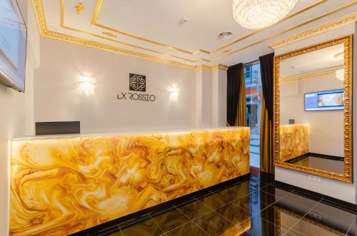 a dressing room with a gold framed bench and a mirror at Hotel LX Rossio in Lisbon