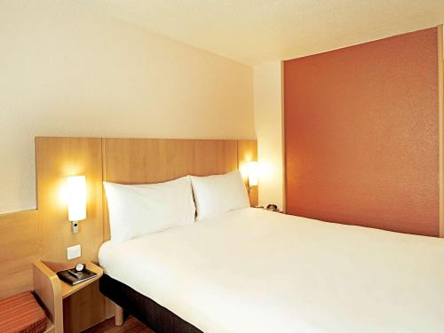 A bed or beds in a room at Hotel ibis Lisboa Jose Malhoa