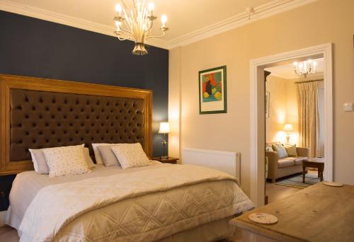 1 dormitorio con 1 cama grande y 1 mesa en Ascot House Hotel, en Torquay