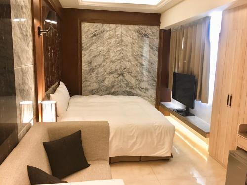 Кровать или кровати в номере Hotel Maple Taiwan Boulevard