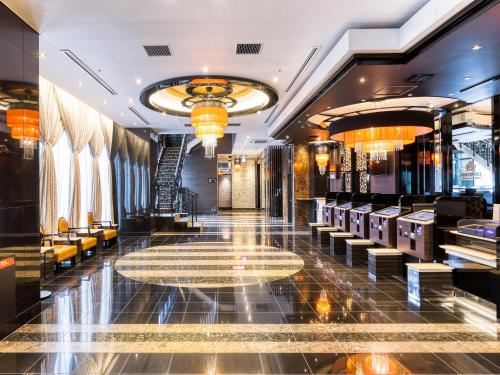 a lobby of a hotel with chairs and a table at APA Hotel Hiroshima Ekimae Ohashi in Hiroshima