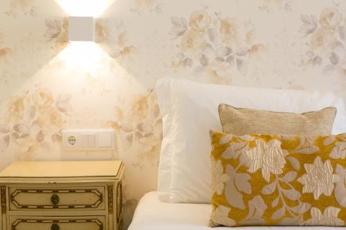 a bedroom with a bed and a side table with a lamp at Suites Amália Guesthouse near Rossio Square in Lisbon