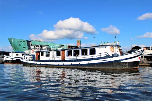 two boats are docked at a dock in the water at AmicitiA in Amsterdam