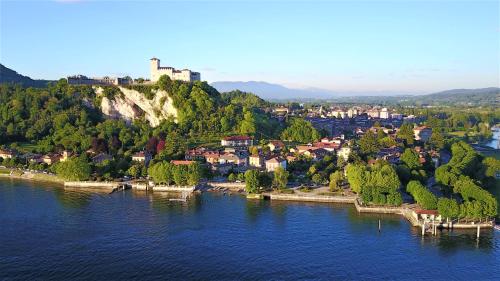 an aerial view of a town on a hill over water at Hotel Dei Tigli in Angera