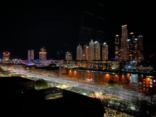 a view of a city at night with lights at Believe Madero Hotel in Buenos Aires