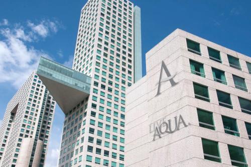 a view of a k wall building with two tall buildings at Live Aqua Ciudad de Mexico Bosques de las Lomas in Mexico City