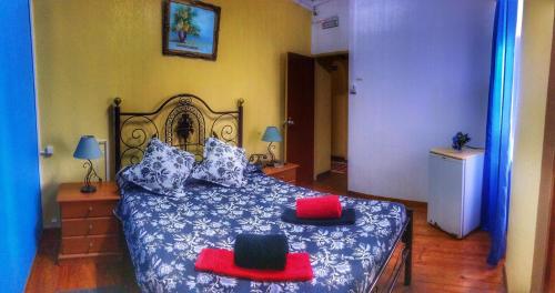 a bedroom with a bed with two hats on it at Pensao Residencial Flor dos Cavaleiros in Lisbon