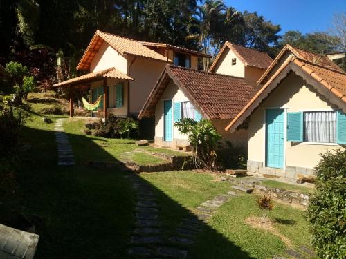 una casa con puertas azules y un patio en Pousada dos Anjos, en São Pedro da Serra