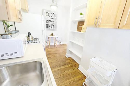 a kitchen with a sink and a counter top at Dallas Native, Lower-Greenville Ave Area in Dallas