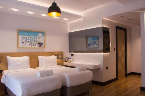 a hotel room with two beds and a bathroom at Four-G Hotel in Istanbul