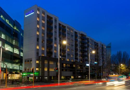 a tall building on a city street at night at Nesuto Stadium in Auckland