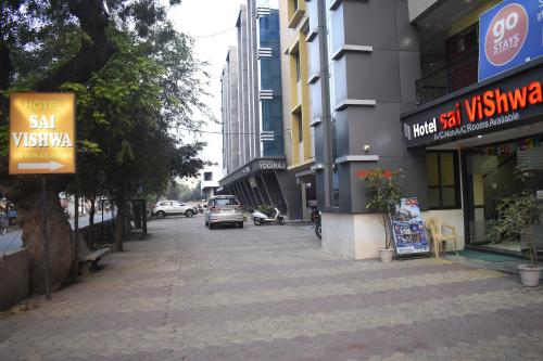 a city street with cars parked on the street at Hotel Sai Vishwa in Shirdi