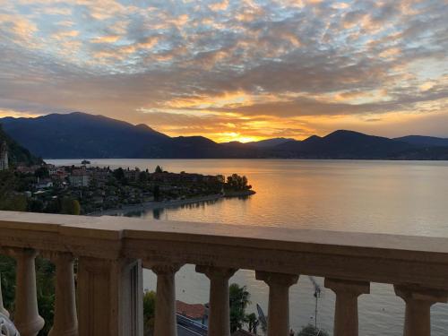 a view of a body of water with a sunset at Hotel La Rondinella in Cannero Riviera