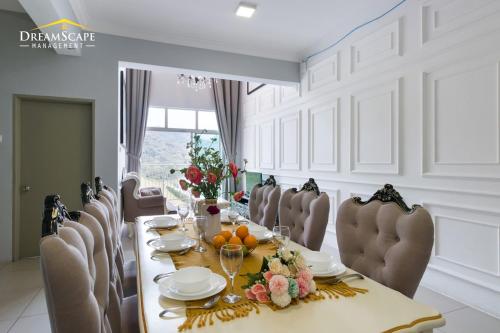 a dining room with a long table and chairs at Zetter Suites @ Cameron in Cameron Highlands