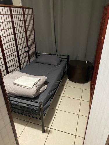 ein kleines Bett in einer Ecke eines Zimmers in der Unterkunft Private Cubicle - Single Bed - Mixed Shared Dorm - MIAMI AIRPORT in Miami