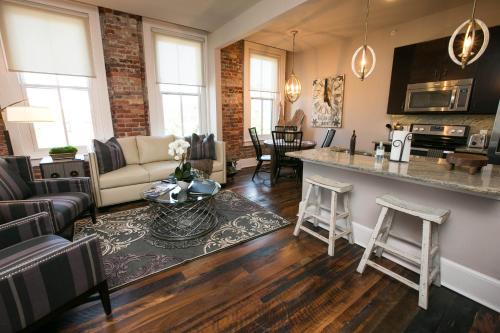 a kitchen and living room with a couch and a table at The Windsor - Asheville in Asheville